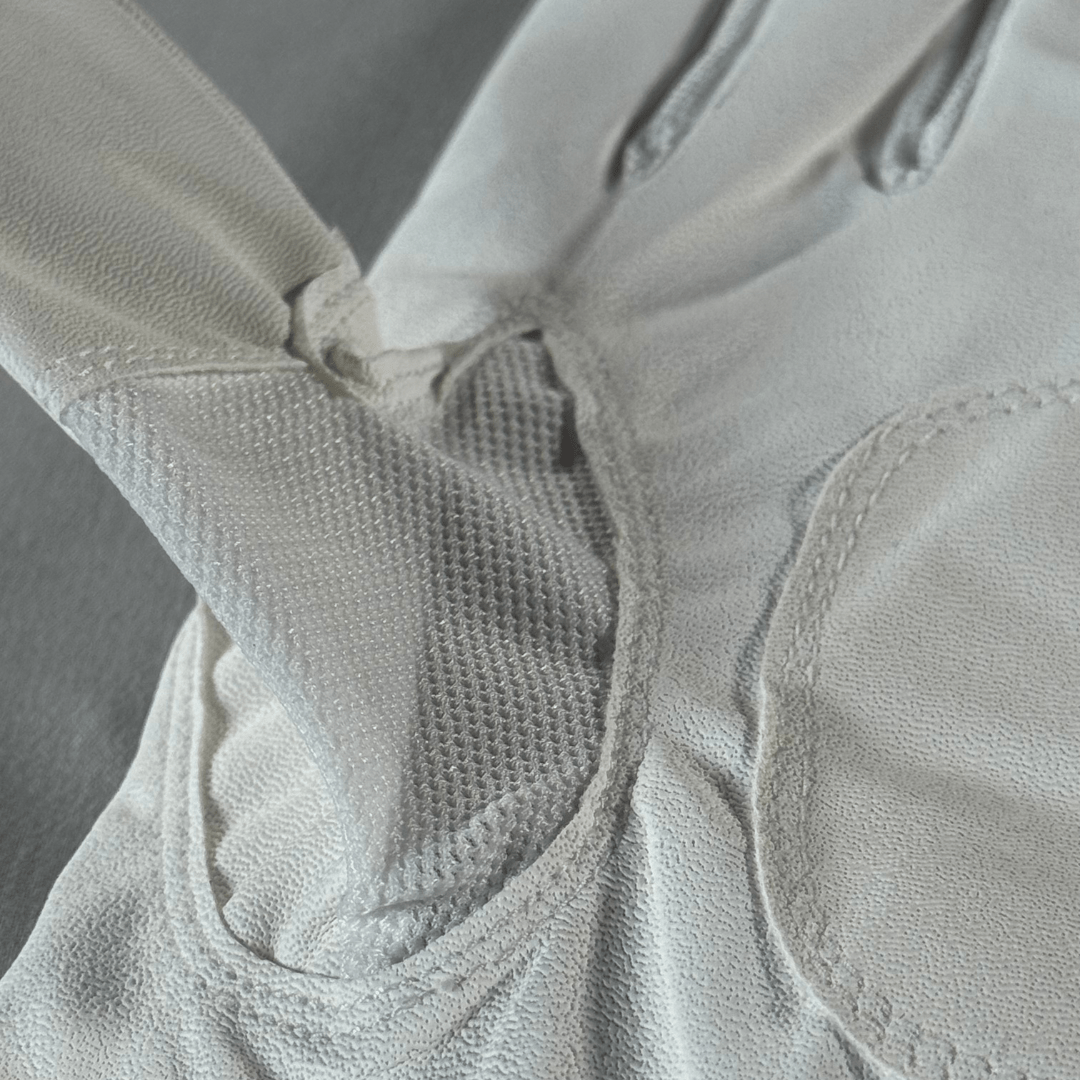 Golf glove with breathable thumb vent for airflow and comfort in hot weather mesh vent