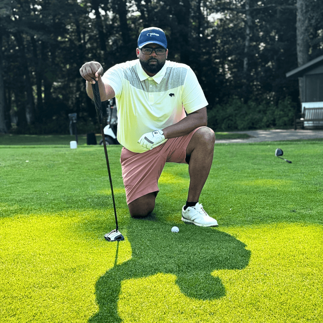 Golfer wearing Lone Buffalo polo and Comy-Cool golf glove kneeling on tee box holding driver